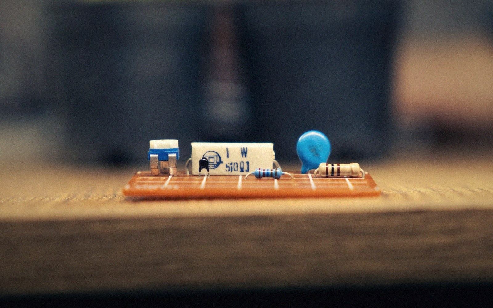 Resistors, a capacitor and a blue diode mounted on a small circuit board