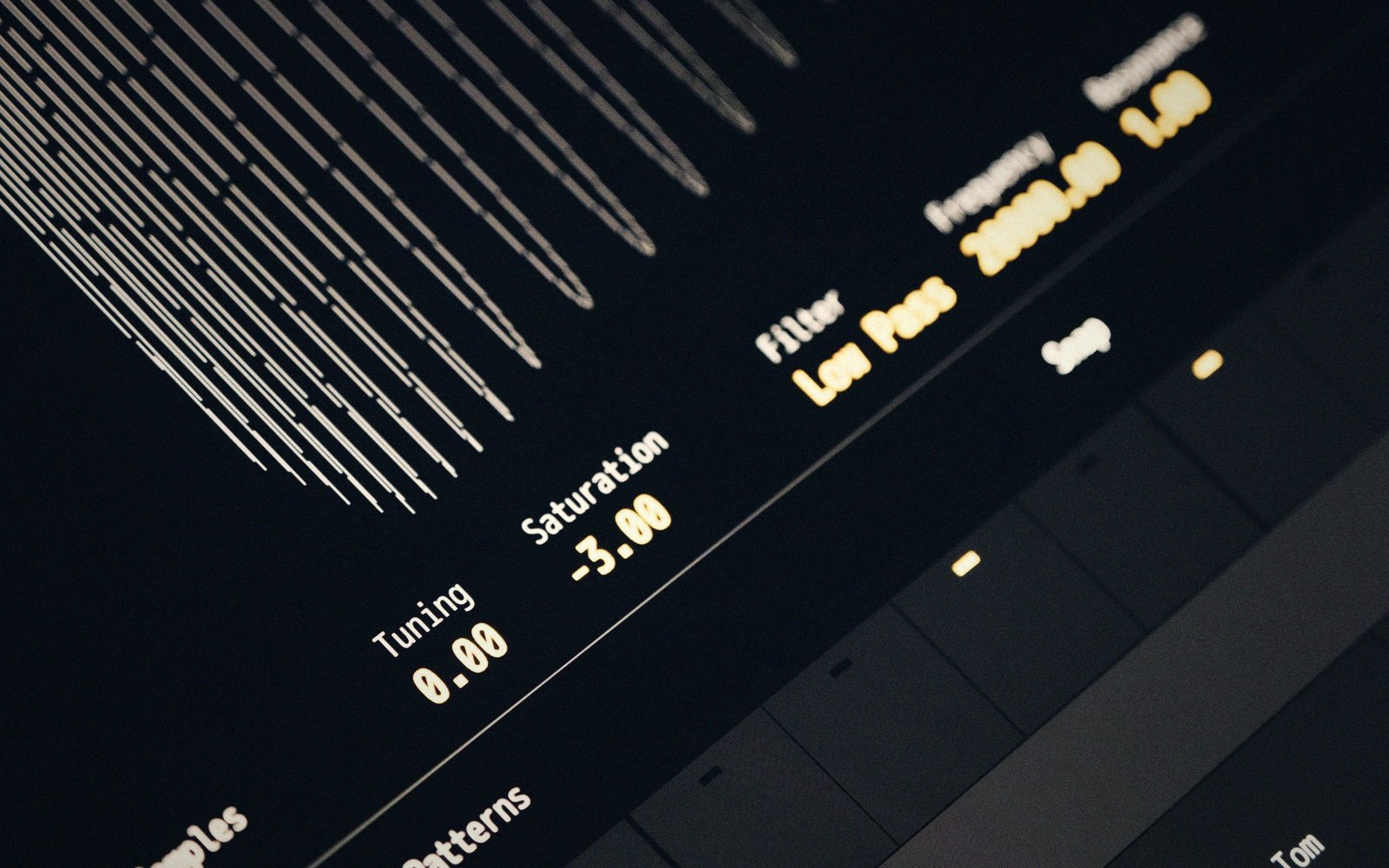 Close-up of a music production interface showing low-pass filter, tuning, and saturation settings